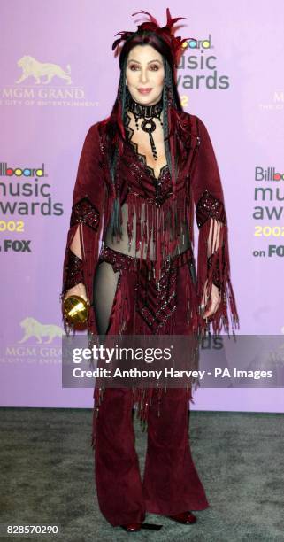 Singer Cher poses for photographers with her 'Artist Achievement Award' during the Billboard Music Awards at the MGM Grand Hotel in Las Vegas. * The...