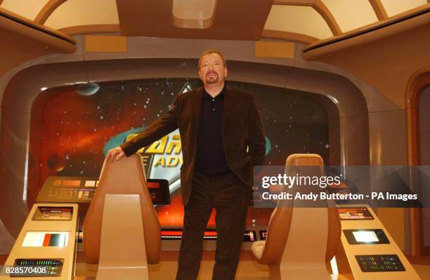 Former commander of the Starship Enterprise Captain Kirk sits on the bridge of a mock up of the Enterprise at Star Trek: The Adventure - an...