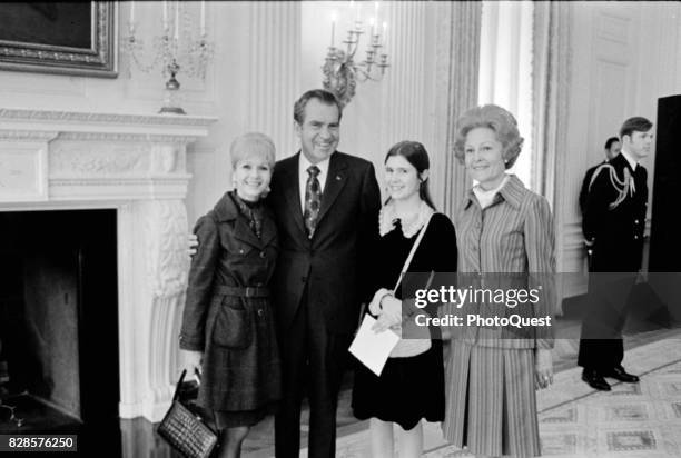 Group portrait of, from left, American actress Debbie Reynolds , US President Richard Nixon , Reynolds' daughter, actress Carrie Fisher , and First...