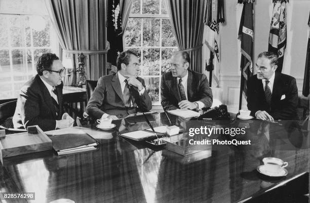 From left, US Secretary of State Henry Kissinger and US President Richard Nixon listen to Congressman and vice president-designate Gerald R Ford ,...