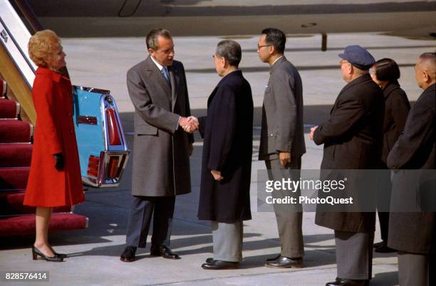 At at the foot of Air Force One's airstair, US President Richard Nixon shakes hands with Premier of the People's Republic of China En-Lai Chou as...