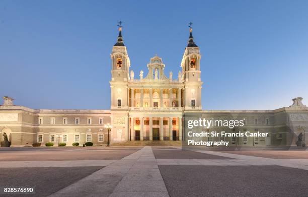 almudena cathedral illuminated at dusk in madrid, spain - bell tower tower stock pictures, royalty-free photos & images