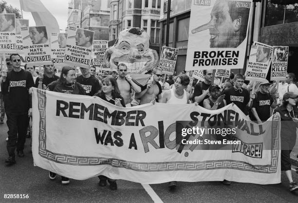 Members of Outrage! carry pictures of Tony Blair with the title 'Broken Promises' at the Gay Pride Mardi Gras parade in London, 3rd July 1999.