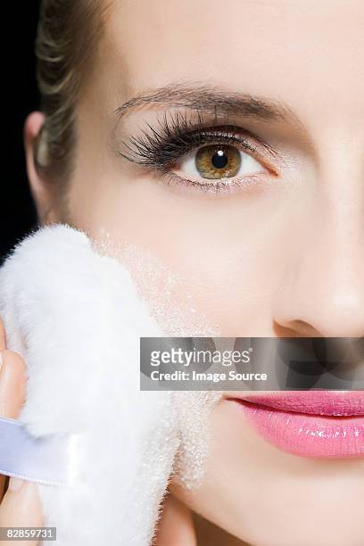 woman applying face powder - powder puff stock pictures, royalty-free photos & images