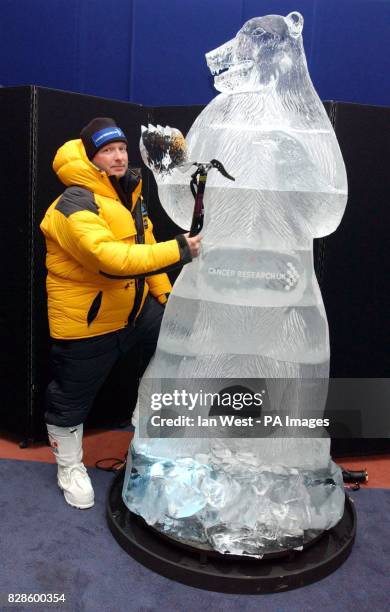 Jim McNeill, dressed in full polar suit and flanked by a 7'foot ice sculpture of a Polar Bear, during a photocall at the Natural History Museum,...