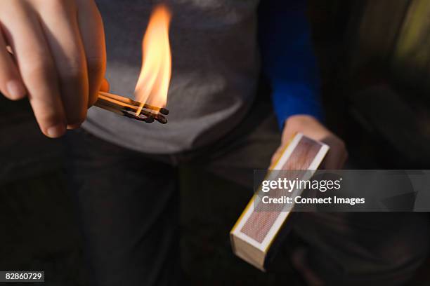 boy playing with fire - streichhölzer stock-fotos und bilder