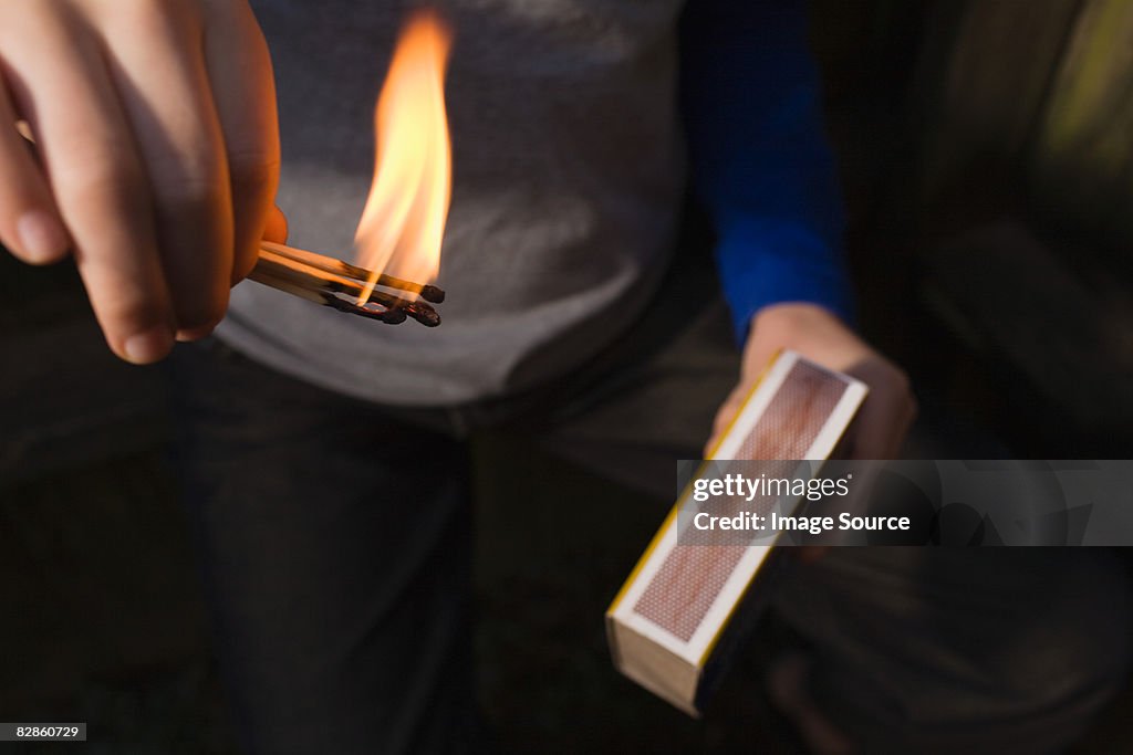 Boy playing with fire