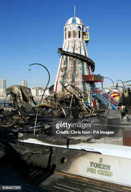 The charred remains of the ghost train ride and the helter skelter on Brighton Pier in West Sussex following a fire on the structure.