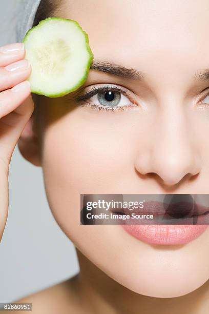 woman with cucumber slice - compassionate eye stock pictures, royalty-free photos & images