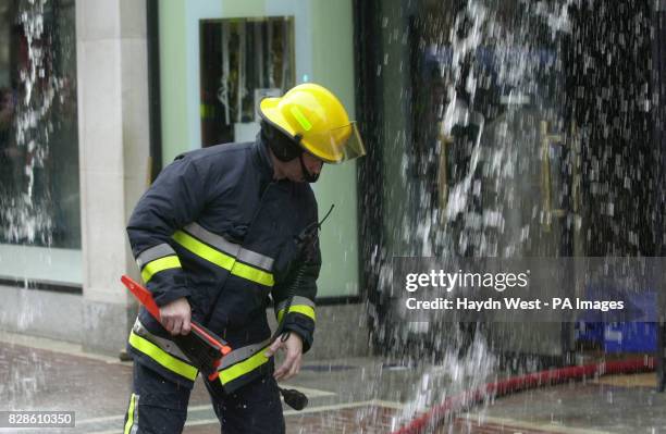 Fireman outside Ireland's top department store , Brown Thomas, on Grafton Street in Dublin as appliances pump water from part of the premises, after...