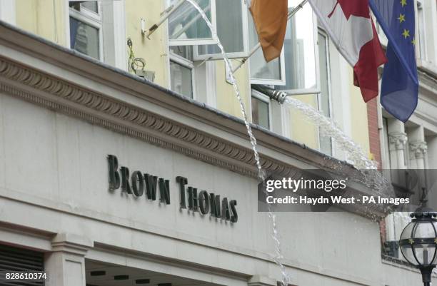 Water being pumped by fire appliances from Brown Thomas department store on Grafton Street in Dublin, after fire sprinklers were accidentally...
