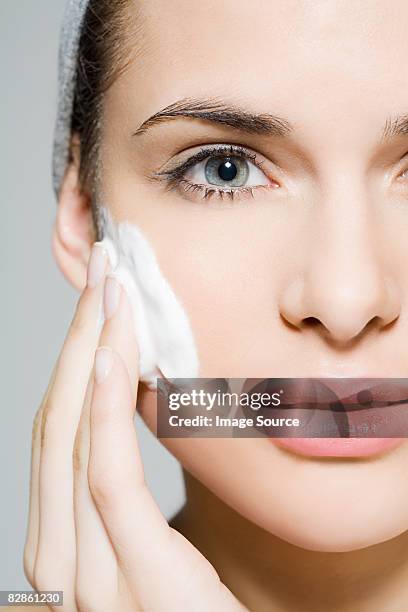 woman cleansing - facial cleanser stockfoto's en -beelden