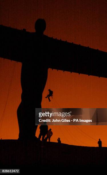 Rigger climbs the Angel of the North as pro-hunting campaigners hang a huge banner from Britain's largest sculpture as an early Valentine's message...