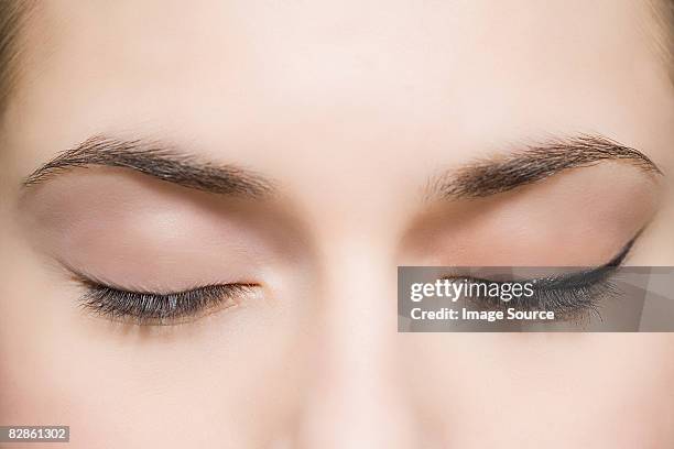 woman with eyes closed - eyeliner ストックフォトと画像
