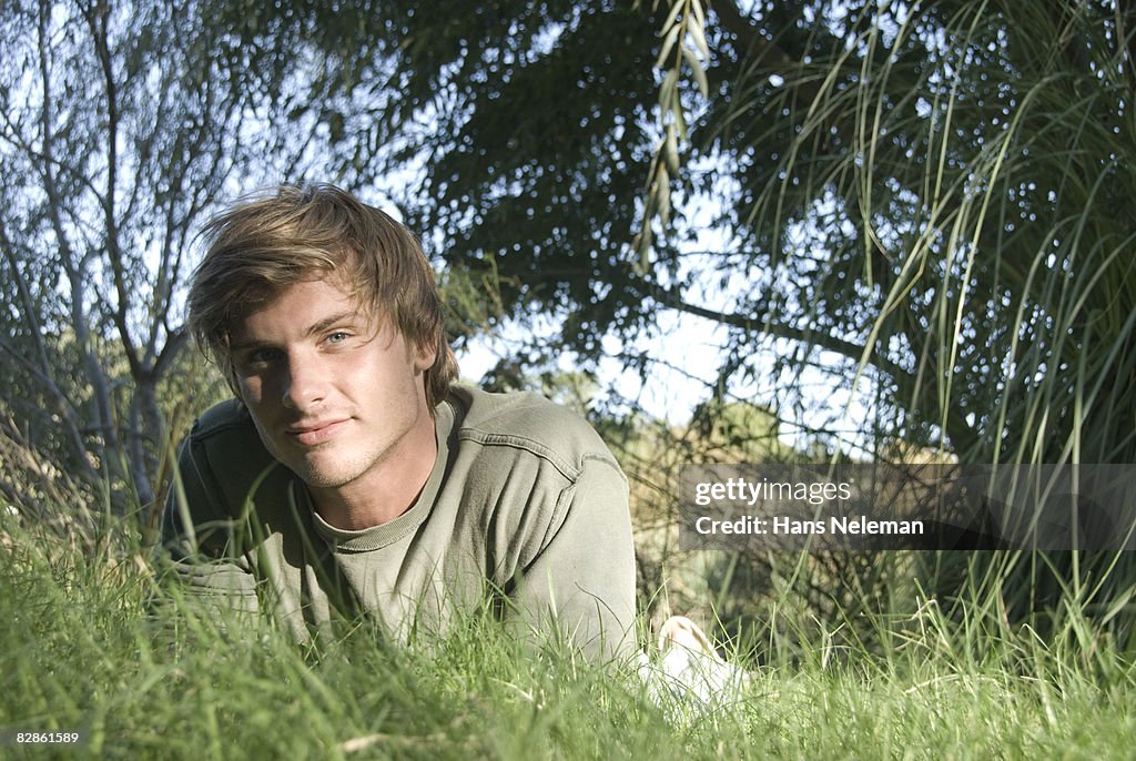 Young man laying in the grass