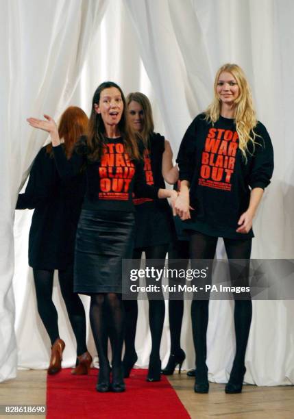 Designer Katharine Hamnett and model Jodie Kidd at the end of her autumn/winter 2003 collection catwalk show as part of London Fashion Week at...