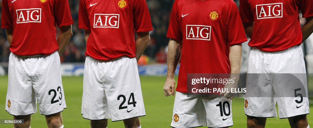 Manchester United players wear shirts wi