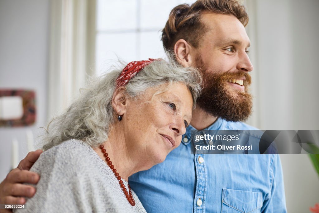 Mother and smiling adult son