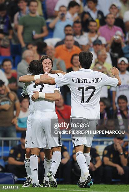 Real Madrid' Spanish defender Sergio Ramos celebrates his goal against Bate Borisov with teammates Raul and Ruud Van Nistelrooy during their...