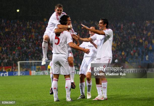 Daniel van Buyten of Bayern is celebrated by his team mates after scoring the 0:1 goal during the UEFA Champions League Group F match between FC...