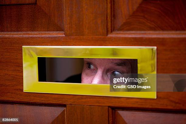 man looks through letter flap - gluren stockfoto's en -beelden