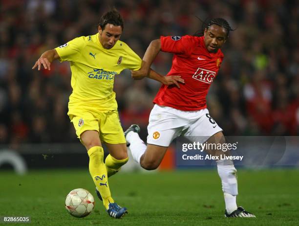 Santi Cazorla of Villareal holds off the challenge of Anderson of Manchester United during the UEFA Champions League Group E match between Manchester...