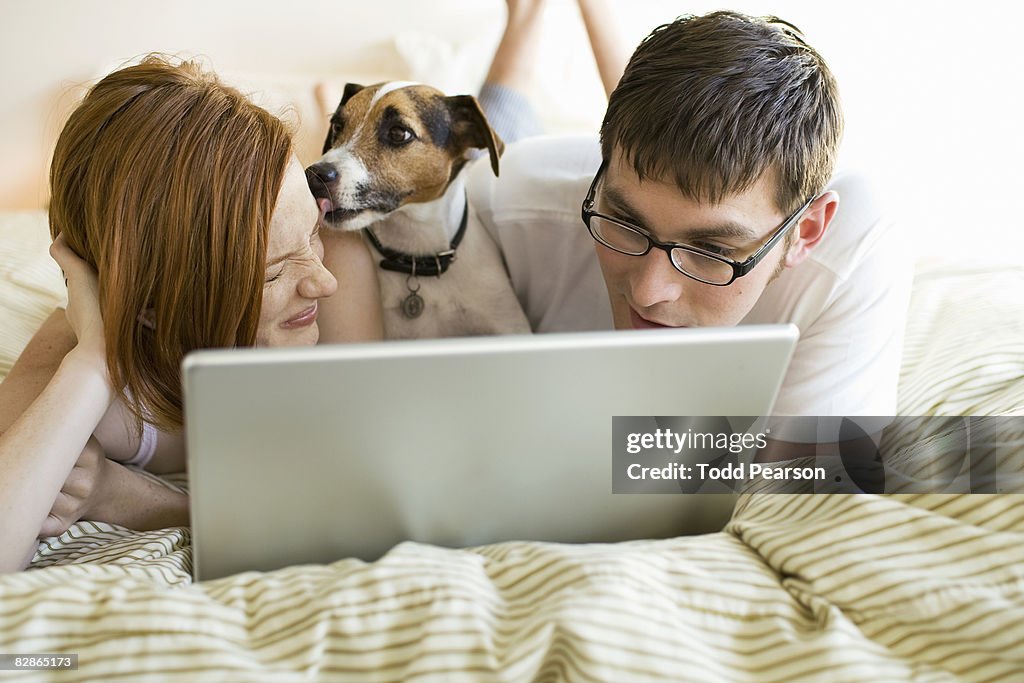 Couple, their dog, and laptop