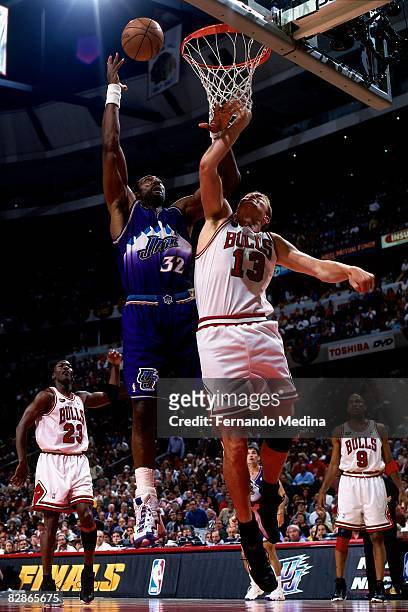 Karl Malone of the Utah Jazz rebounds against Luc Longley of the Chicago Bulls in Game Five of the 1998 NBA Finals at the United Center on June 12,...
