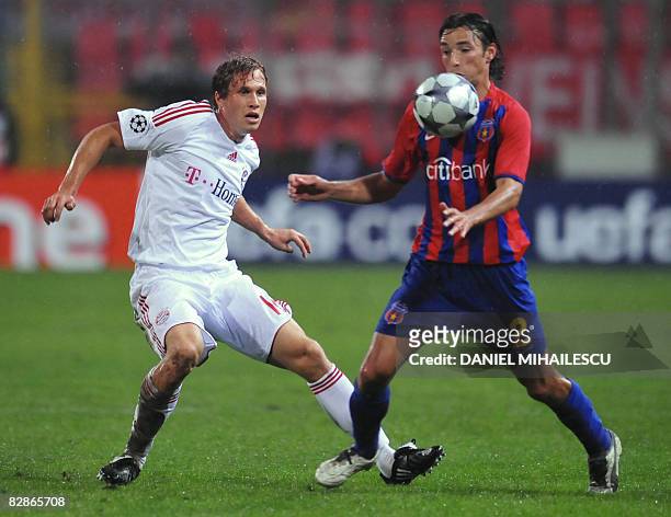 Bayern Munich's Andreas Ottl vies for the ball with Steaua Bucuresti's George Ogararu during the Champions League football match on Ghencea Stadium...