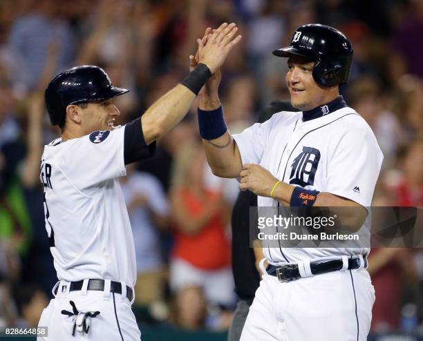 Ian Kinsler of the Detroit Tigers celebrates with Miguel Cabrera of the Detroit Tigers after scoring against the Pittsburgh Pirates on a three-run...