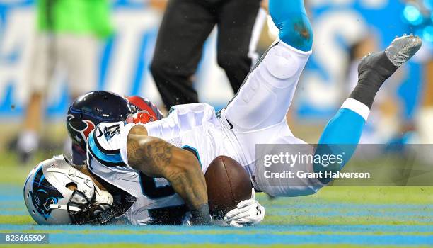 Damiere Byrd of the Carolina Panthers holds on for a touchdown as Marcus Gilchrist of the Houston Texans defends during their preseason game at Bank...