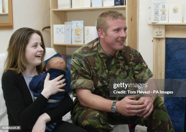 Fiance Leanne Stacey and Royal Marine Anthony Crouch, who has returned from service in the Gulf watch the TV coverage of the moment earlier in the...