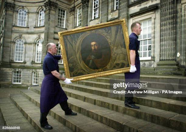 Sotheby's technicians Brian Lamont and Scott Riddell carry one of the earliest known portraits of Scots freedom fighter William Wallace outside...