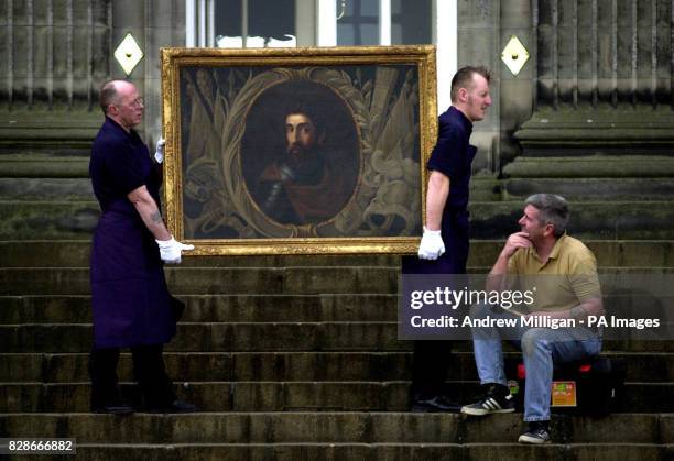 Sotheby's technicians Brian Lamont and Scott Riddell carry one of the earliest known portraits of Scots freedom fighter William Wallace outside...