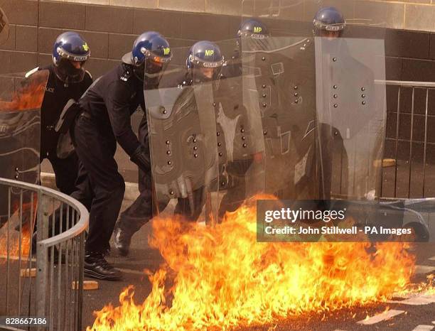 Group of police officers come under a petrol bomb attack, as part of a demonstration for Sir John Stevens during his visit to the force's new...