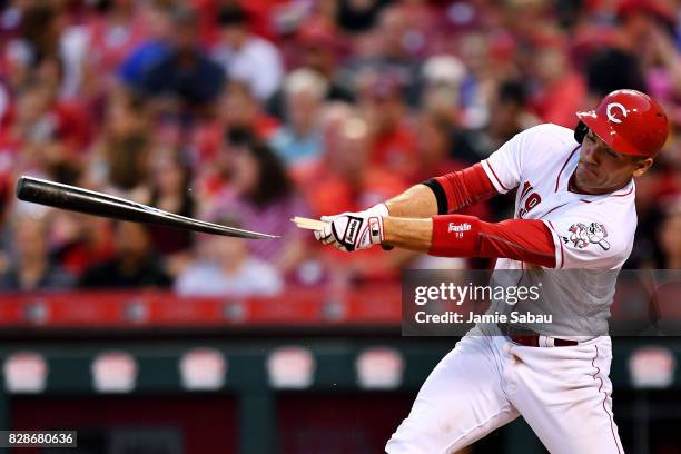 Joey Votto of the Cincinnati Reds breaks his bat on a single in the fourth inning against the San Diego Padres at Great American Ball Park on August...