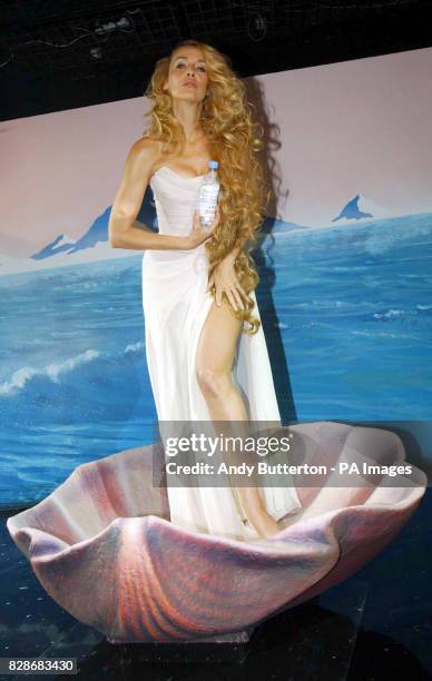 Model Jerry Hall launches 'Heaven by Evian' in the window of Selfridges department store in central London. Jerry was recreating Botticelli's 'The...