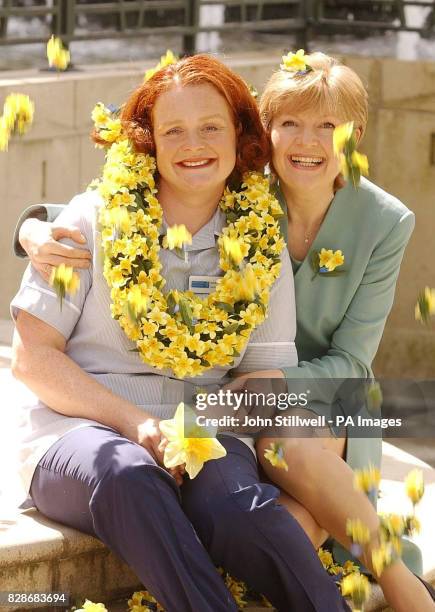 Jayne Unwin from Stockton-on-Tees celebrates in London after winning the Marie Curie/Clinton Cards Nurse of the Year for England award, with Cathy...