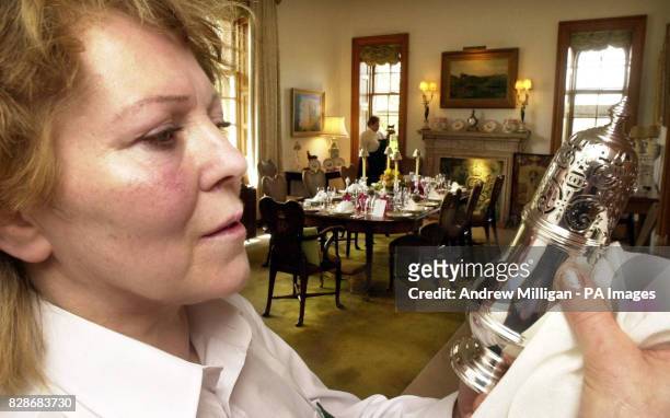 Guide at the Castle of Mey, Nancy McCarthey polishes a sugar shaker in the dining room, as staff at the former summer retreat of the Queen Mother...