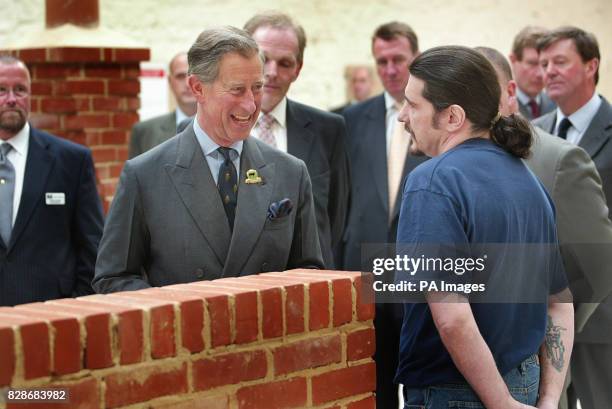 The Prince of Wales talkes to 'Malcolm' in the Brick Workshop, during a visit to Dartmoor Prison. The Prince of Wales had a taste of life behind bars...