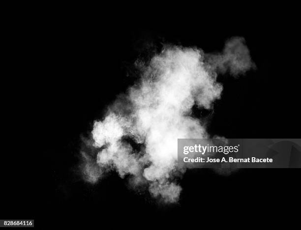 forms and textures of an explosion of a powder of color white on a black background - smoke black background ストックフォトと画像