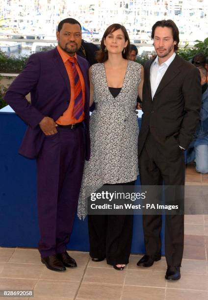 Actors from left to right; Laurence Fishburne, Carrie-Anne Moss and Keanu Reeves pose for photographers during a photocall to promote their new film...