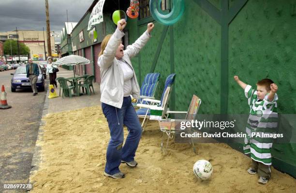 Young boy gets some instruction outside a pub in the Barra`s area of Glasgow as fans gather to watch the Celtic Porto match on television this...