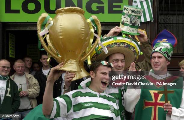 Celtic fans, one dressed as the Pope , gather outside a pub in the Barra`s area of Glasgow, waiting for the Celtic v Porto game to begin.