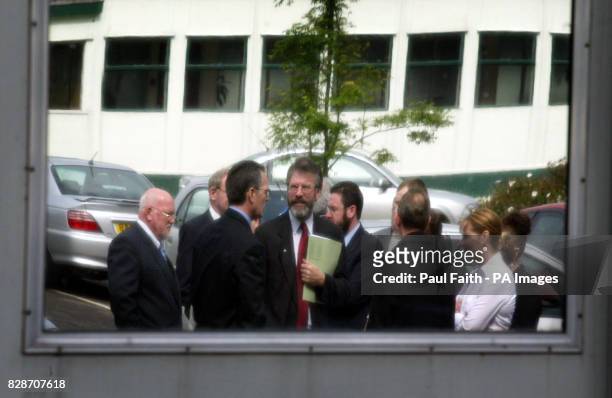 Sinn Fein President Gerry Adams with party members, reflected in a security mirror, after handing a letter of protest to the government at Stormont...