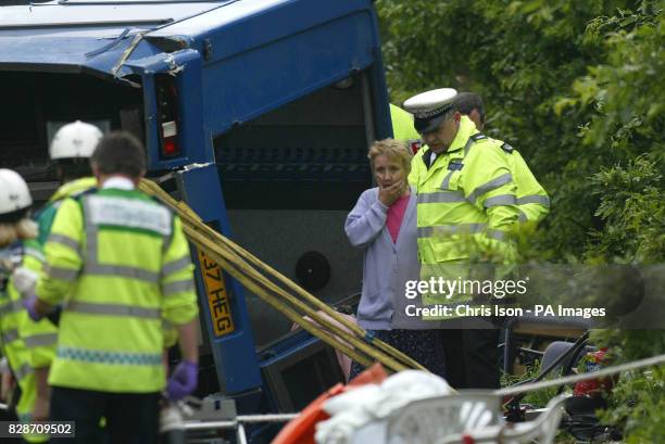 Police officer helps a woman at the scene of an eight vehicle crash on the A36 near West Wellow, Hampshire. At least one person died in the seven...
