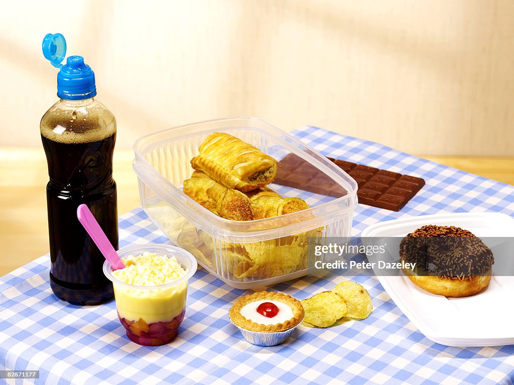 Unhealthy lunch box on table cloth