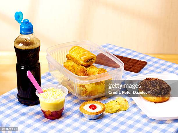 unhealthy lunch box on table cloth - sausage roll stock pictures, royalty-free photos & images