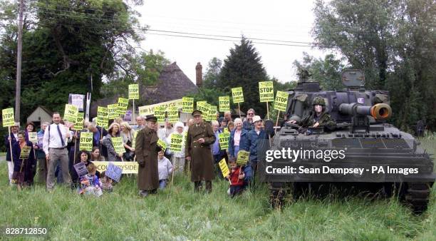 Protester Ed Jones, wearing a Tony Blair mask, sits on a tank outside the medieval Three Horseshoes pub at Mole Hill Green, Essex, near Stansted...