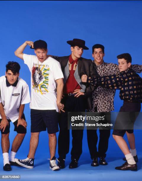 Portrait of American pop group New Kids on the Block posed against a blue background, Los Angeles, California, 1989. Pictured are, from left,...